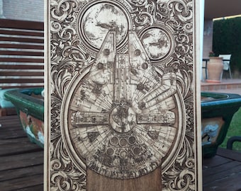 May include: A wooden plaque with an intricate, carved design featuring a detailed image of the Millennium Falcon spaceship from Star Wars. The plaque has a dark brown wood finish.