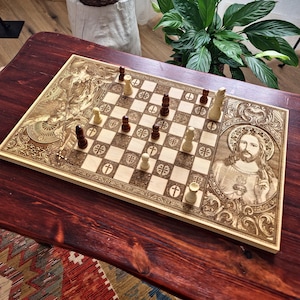 May include: A wooden chess set with intricately carved religious imagery. The board features a detailed depiction of Jesus and other religious figures. The chess pieces are in play on the light-colored board, with dark and light pieces.