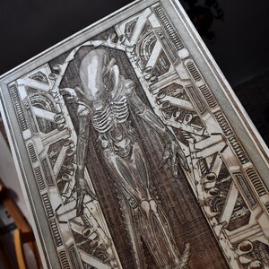 Sci fi creature wall art with detailed biomechanical skeletal design