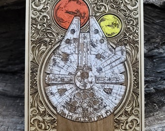 May include: A wooden plaque with an intricate, ornate design featuring a detailed illustration of the Millennium Falcon spaceship. The plaque is decorated with a red and yellow circle design.