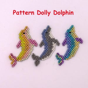 May include: Three beaded dolphin patterns in yellow, gray, and rainbow colors. The dolphins are made of small beads and have a curved shape. The text "Pattern Dolly Dolphin" is in red above the dolphins.