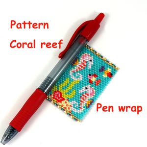 May include: A turquoise blue beaded pen wrap with a coral reef pattern featuring seahorses, fish, and coral. The text "Pen wrap" is written below the beaded wrap.