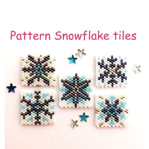 May include: Five white square tiles with blue and brown snowflake designs. The tiles are surrounded by small blue and silver stars.