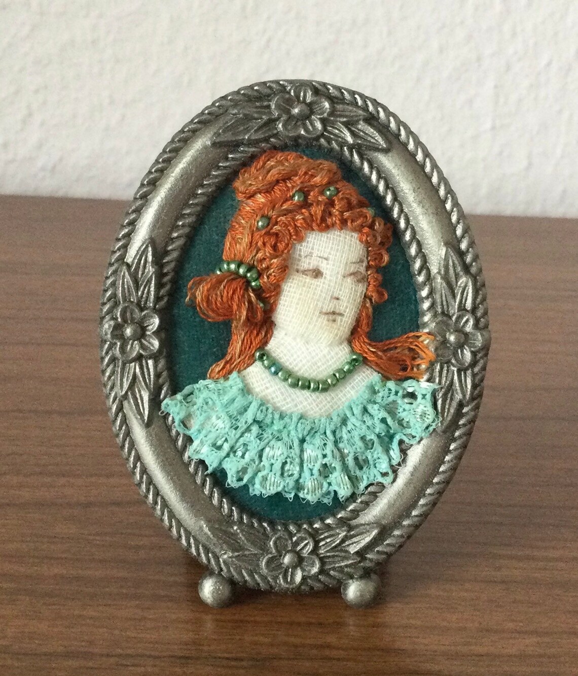 Raised embroidered portraits of Victorian ladies. Framed in Etsy