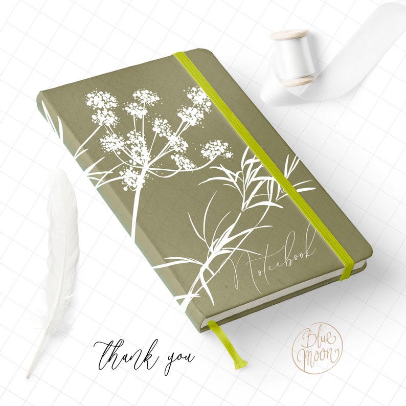 May include: A green notebook with a white floral design and a yellow elastic band. The notebook says "Notebook" on the cover. The text "Thank you" is written below the notebook. The text "Blue Moon" is written in a circle below the notebook.