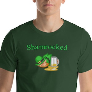 May include: A green t-shirt with the text "Shamrocked" and a cartoon image of a leprechaun with a beer mug.
