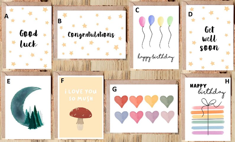 May include: A collection of greeting cards with various designs and messages. Cards include "Good Luck", "Congratulations", "Happy Birthday", and "Get Well Soon". Other cards feature watercolor illustrations of balloons, hearts, a mushroom, a moon, and trees. Each card has a brown border.