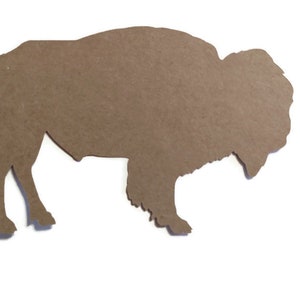 May include: A brown cardboard cutout of a bison silhouette.