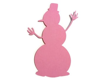 May include: A flat, pink paper cutout in the shape of a snowman. The figure consists of three stacked circular sections, a top hat on the head, a pointed nose, and two thin, multi-pronged arms extending outward from the middle section.
