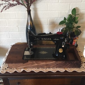 Sewing machine base with table extension