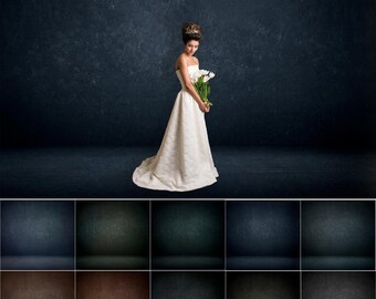 May include: A bride in a white wedding dress holds a bouquet of white flowers. She is standing on a dark blue textured background.