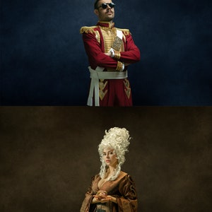 May include: A man in a red and gold military uniform with a white sash and sunglasses stands with his arms crossed. A woman in a brown dress with a white wig holds a small object in her hands.