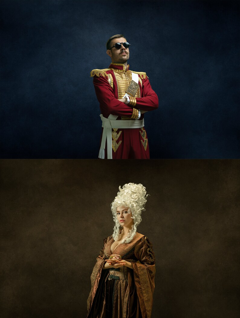 May include: A man in a red and gold military uniform with a white sash and sunglasses stands with his arms crossed. A woman in a brown dress with a white wig holds a small object in her hands.