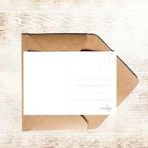 May include: A blank white postcard with a brown envelope. The postcard has a space for a stamp and lines for writing an address. The envelope is folded over the postcard and has the word "courier" printed on it.