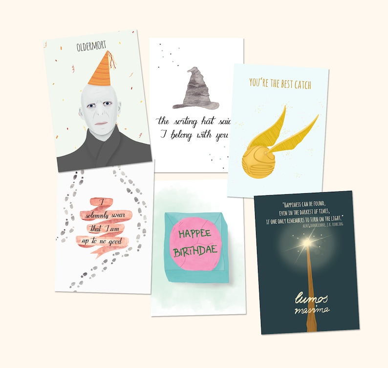 May include: Set of six illustrated greeting cards featuring Harry Potter themed designs. The cards feature a sorting hat, a snitch, a wand, a quote about happiness, a birthday card, and a card with the character Voldemort.