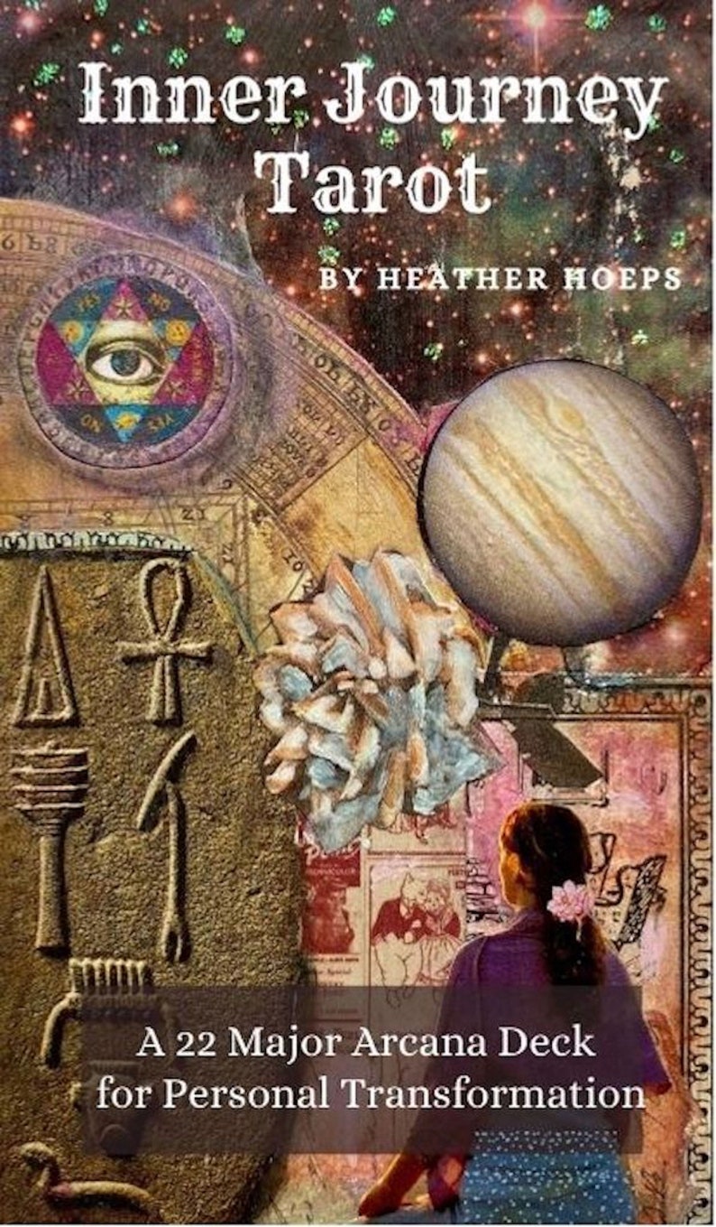 May include: The image showcases the "Inner Journey Tarot" deck by Heather Hoeps. The design features celestial and ancient symbols, including an eye within a triangle, a planet, and Egyptian hieroglyphs. The text reads "A 22 Major Arcana Deck for Personal Transformation."