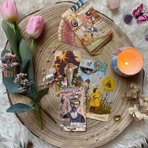 May include: A collection of tarot cards with vintage-style illustrations, including a card with the text "IV - Leadership". The cards are arranged on a wooden slice with flowers, crystals, and a lit candle, creating a mystical aesthetic.
