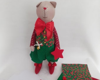 May include: A handmade Christmas cat sewing kit with red and green fabric, a red star, a bell, and a bow. The instructions are written in German.