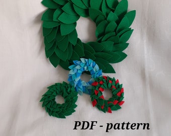 May include: A PDF pattern for making felt wreaths in three sizes: green, blue, and red. The text "PDF - pattern" is printed below the wreaths.