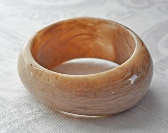 Old Lucite fawn marbled bangle, bracelet.  Asymmetric and oval outside shape, circular wrist opening.