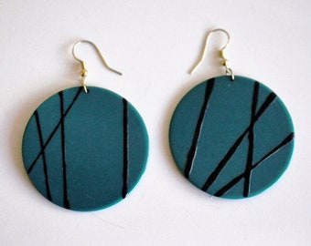 Large Forest Green French Bakelite disc earrings.  Raised painted black lines, different on each, form minimalist patterns across the discs.