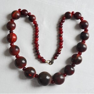 Round Bone bead necklace.  Gerda Lynggaard for Monies dyed, deep red, carved bone bead medium long necklace.  Designer 1980s bone necklace.