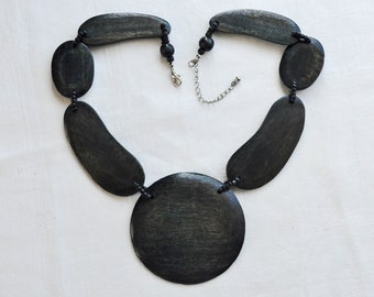 Large wooden, Gerda Lynggaard for Monies pendant, necklace..  Dark washed Teak central disc and flat, curved, bean shaped side panels.  80s.