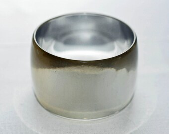 Wide silvery bangle, bracelet.  Silver Lucite, slightly domed, Mod bangle.  Reflective, completely silver, tall, thin walled Hippie bangle.