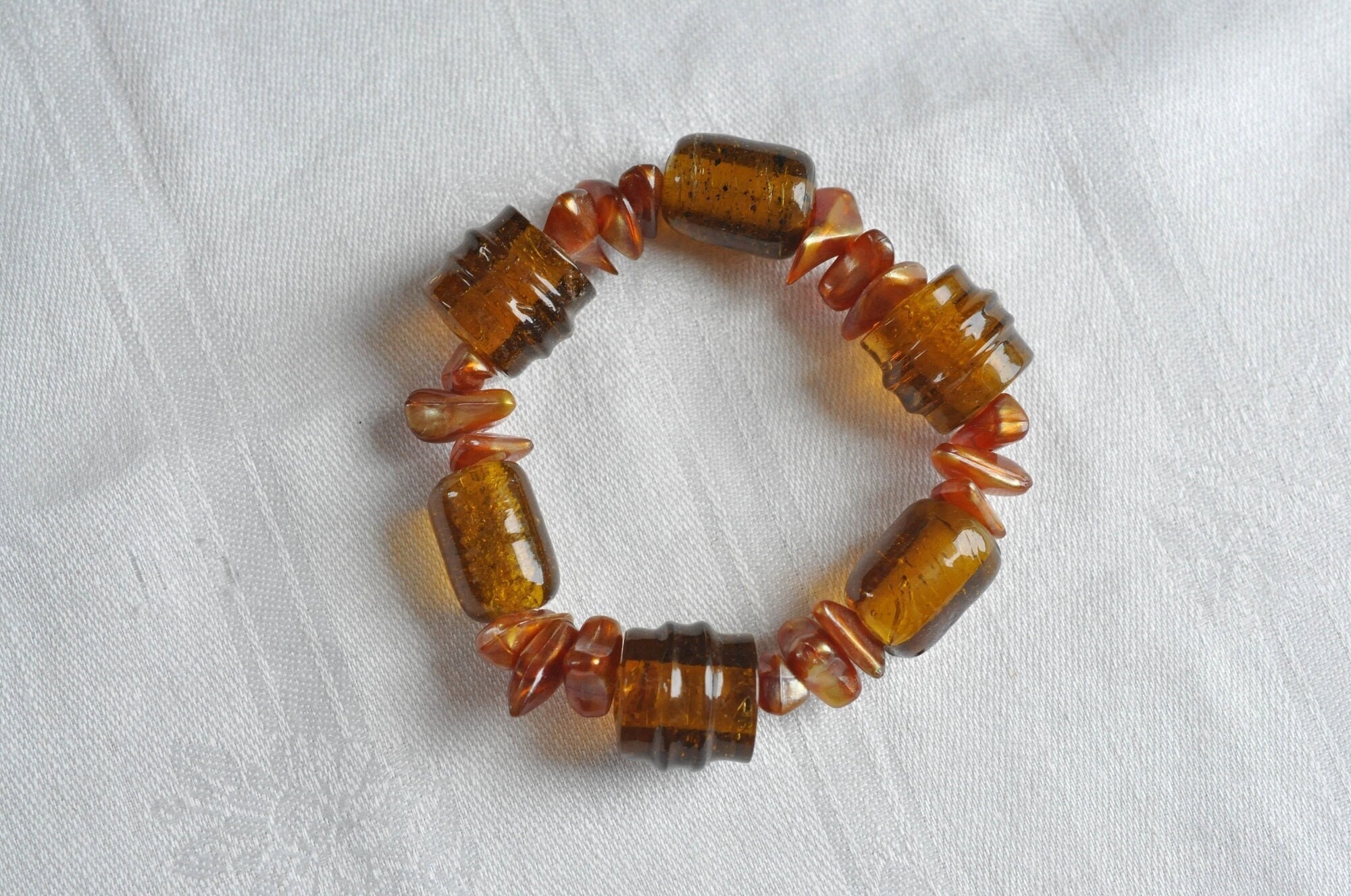 Brown glass bead and MOP bracelet.  Large barrel and cylinder beads, separated by Mother of Pearl chips.  1950s Deco Revival glass bracelet.