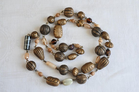 Carved Brass and Glass bead flapper necklace.  Retro, 60s long necklace.  Large, different shaped and carved brass beads.  Hippie necklace.