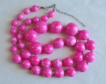 Hot Pink marbled Lucite necklace.  Graduating ball beads, hand knotted between each bead with pale pink cotton cord.  Art Deco Revival, 70s.