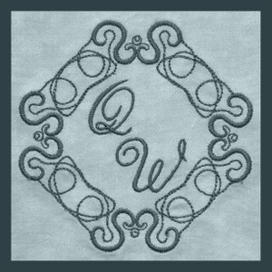 May include: An embroidered design featuring the letters "QW" in a stylised script font, surrounded by an intricate, swirling border. The design is stitched in a dark grey thread on a light blue fabric.