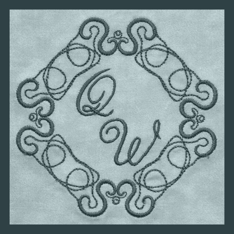 May include: An embroidered design featuring the letters "QW" in a stylised script font, surrounded by an intricate, swirling border. The design is stitched in a dark grey thread on a light blue fabric.