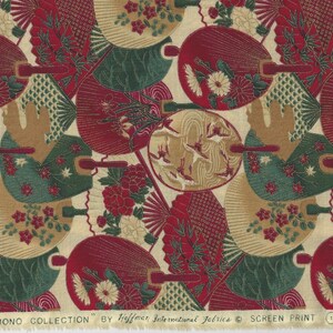 May include: A fabric with a repeating pattern of red, green and gold fans. The fabric has a cream background and the text "KIMONO COLLECTION" by Hoffman International Fabrics &copy; SCREEN PRINT.