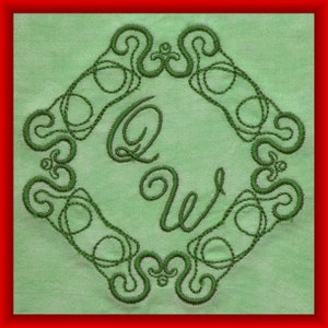 May include: Green embroidered design on a light green fabric background. The design features a decorative border with a stylized letter Q and W in the center.