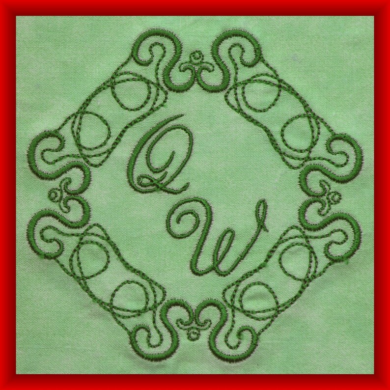 May include: Green embroidered design on a light green fabric background. The design features a decorative border with a stylized letter Q and W in the center.