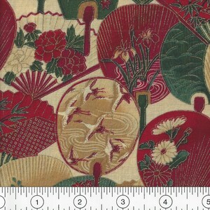 May include: Red and gold fabric with a repeating pattern of fans, flowers, and birds. The fabric is on a cream background and has a ruler for scale.
