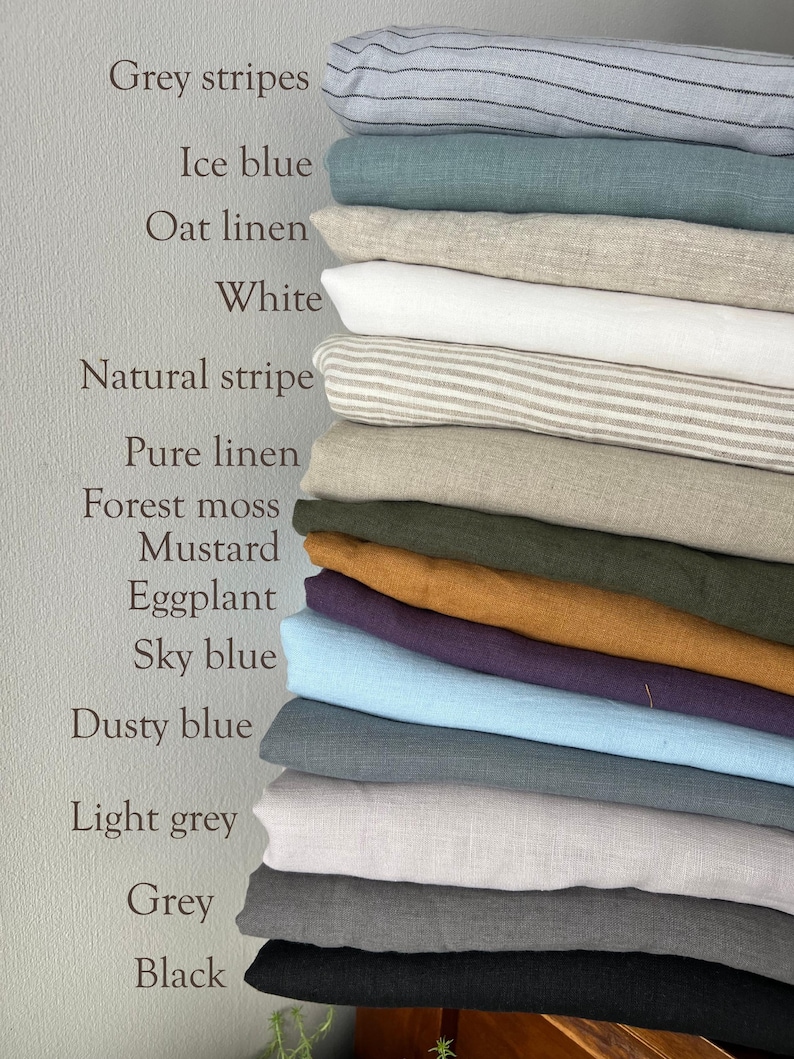 May include: A vertical stack of folded fabric swatches in various colors and patterns, including grey stripes, ice blue, oat, white, natural stripe, pure linen, forest moss, mustard, eggplant, sky blue, dusty blue, light grey, grey, and black.