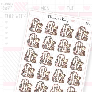 May include: A sheet of 16 planner stickers featuring a cartoon bear with a mirror and bottles of lotion. The stickers are in shades of pink, blue, and brown. The text "Paper Kay" and "552" are visible on the sheet.