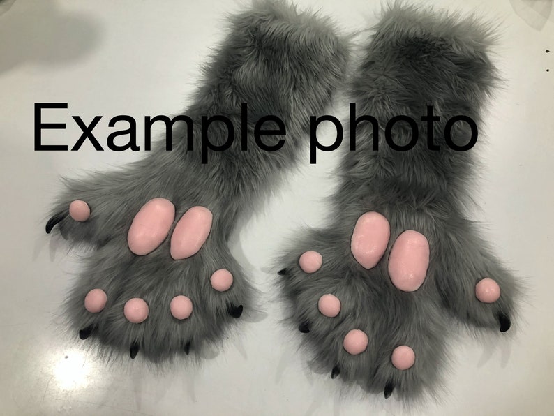 May include: A pair of gray furry paws with pink paw pads and black claws. The paws are attached to furry gray sleeves.