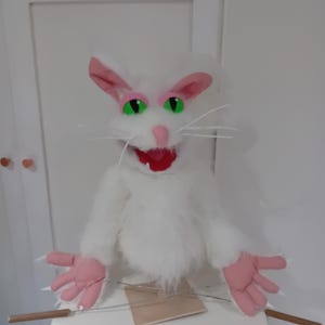 Long fur moving mouth hand puppet with arm rods and tail.