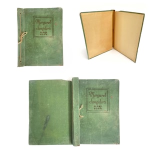 May include: Vintage green scrapbook with the text "Margaret Sangster's SCRAP BOOK" in a rectangular frame. The scrapbook is bound with a string and has aged, yellowed pages. The cover shows signs of wear.