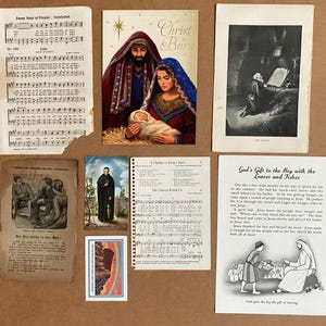 K&ouml;nnte beinhalten: Eine Sammlung religi&ouml;ser Papier-Ephemera, darunter Liedbl&auml;tter mit Notenschrift, ein Krippendruck mit dem Text Christ is Born, eine schwarz-wei&szlig;e Illustration eines M&ouml;nchs, eine Erz&auml;hlkarte &uuml;ber Brot und Fische sowie kleine Karten.