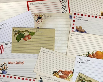 May include: A collection of vintage recipe cards with various designs. The cards feature illustrations of a lobster, a cherry, a rooster, and a teapot. The cards have lined spaces for writing down recipes.