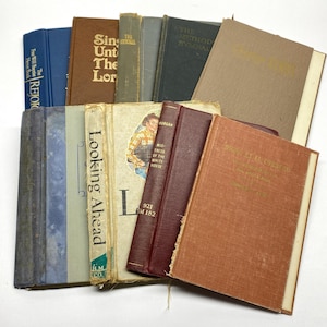 May include: A collection of vintage books with various colors and titles. The books include titles like "Looking Ahead", "Sing Unto The Lord", and "The Method Hymnal". The books are stacked together, showcasing their aged covers and spines.
