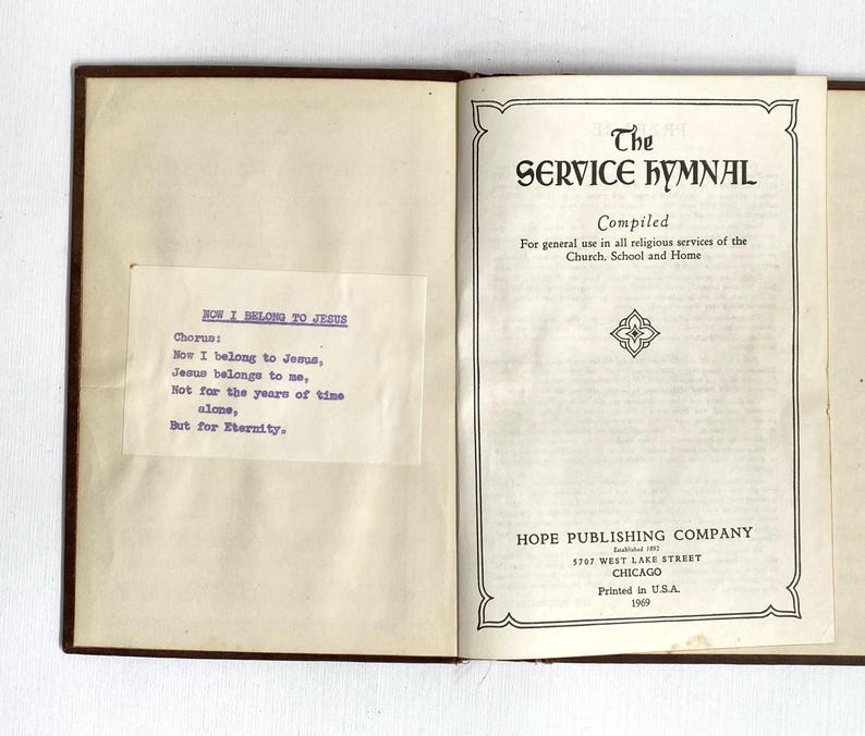 May include: An open book titled "The Service Hymnal" with a brown cover. The title page includes the text "Compiled" and "For general use in all religious services of the Church, School and Home." A smaller page has the text "How I Belong to Jesus."