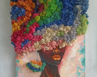 May include: A mixed media wall art piece featuring a painted portrait of a person with dark skin and bright orange lips. The hair is composed of textured, multi-colored preserved moss in shades of blue, green, orange, pink, and cream.