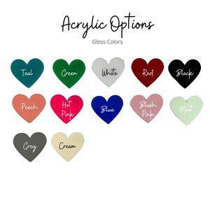 May include: A collection of heart-shaped acrylic options in various gloss colors. Colors include teal, green, white, red, black, peach, hot pink, blue, blush pink, mint, grey, and cream. The text "Acrylic Options" and "Gloss Colors" are displayed.
