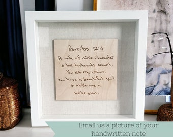 May include: A framed wood plaque with a handwritten message that reads "Proverbs 12:4 A wife of noble character is her husbands crown. You are my crown. You have a beautiful spirit + make me a better man."