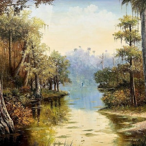 May include: A painting depicting a serene swamp scene, featuring a narrow waterway meandering through a verdant forest. The water is a pale blue, reflecting the sky and the surrounding trees. The trees are a mixture of green and brown, with some adorned with long, trailing Spanish moss. The scene is bathed in a soft, golden light.